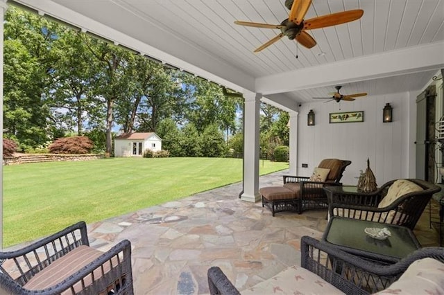 view of patio with an outbuilding and ceiling fan