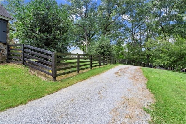 view of gate with a lawn