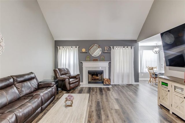 living room featuring hardwood / wood-style floors and vaulted ceiling