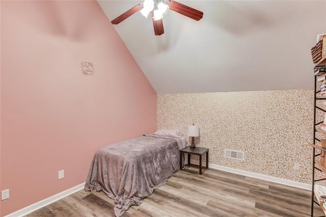 bedroom featuring lofted ceiling, hardwood / wood-style flooring, and ceiling fan