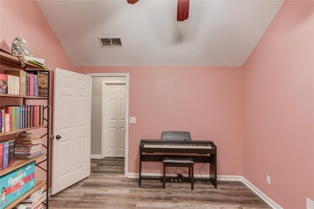 misc room with ceiling fan, hardwood / wood-style floors, and lofted ceiling