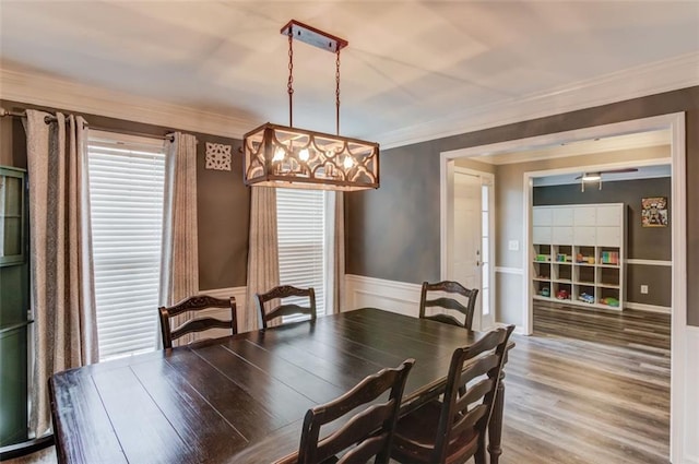 dining area featuring hardwood / wood-style floors and crown molding