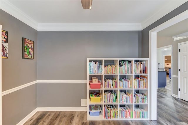 game room with hardwood / wood-style flooring and ornamental molding