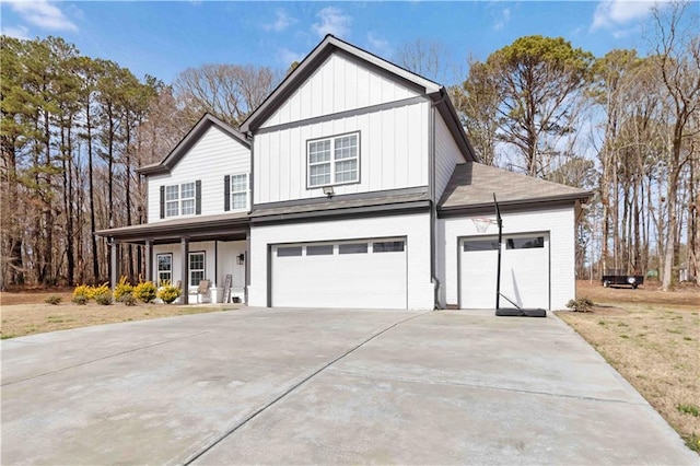 modern farmhouse style home featuring a garage, brick siding, concrete driveway, board and batten siding, and a front yard