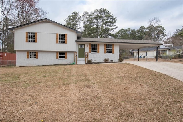 split level home with an attached carport, brick siding, fence, driveway, and a front lawn