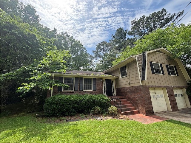4135 Moore Rd, Conley, GA 30288 - split level home with brick siding, a garage, a front yard, and driveway