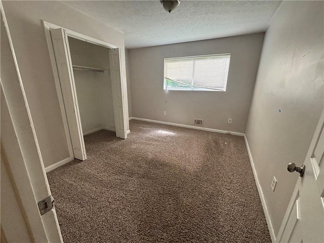 4135 Moore Rd, Conley, GA 30288 - unfurnished bedroom featuring carpet floors, a textured ceiling, baseboards, and a closet
