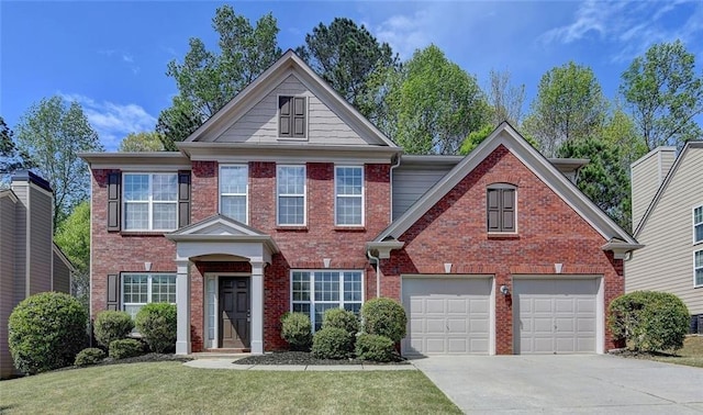 580 Hammersmith Dr, Suwanee, GA 30024 - view of front of house featuring driveway, brick siding, a garage, and a front lawn