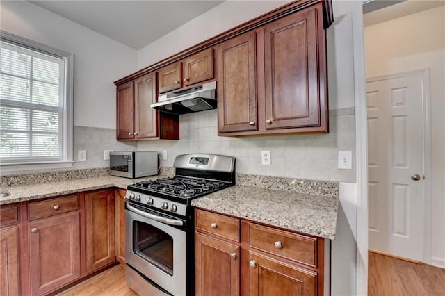 580 Hammersmith Dr, Suwanee, GA 30024 - kitchen with appliances with stainless steel finishes, under cabinet range hood, light wood-style floors, and light stone counters