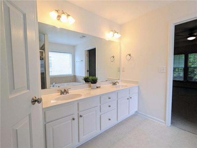 580 Hammersmith Dr, Suwanee, GA 30024 - bathroom featuring double vanity, tile patterned flooring, a bath, and baseboards