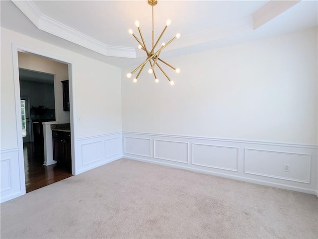 580 Hammersmith Dr, Suwanee, GA 30024 - carpeted empty room featuring a chandelier, crown molding, a decorative wall, a wainscoted wall, and a raised ceiling