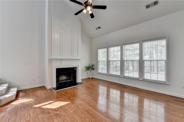 580 Hammersmith Dr, Suwanee, GA 30024 - unfurnished living room featuring healthy amount of natural light, ceiling fan, a fireplace, high vaulted ceiling, and wood finished floors