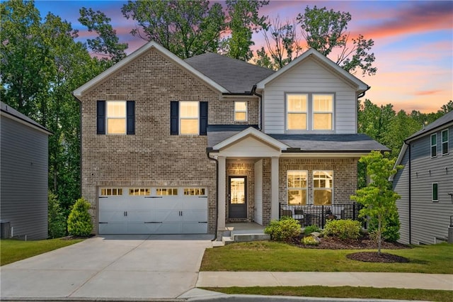 519 Magnolia Dr, Dawsonville, GA 30534 - view of front of home with a porch, brick siding, a garage, driveway, and a lawn
