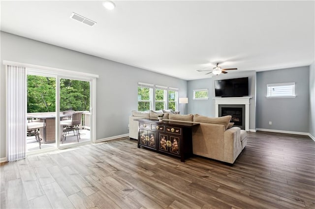 519 Magnolia Dr, Dawsonville, GA 30534 - living room featuring ceiling fan, dark wood finished floors, baseboards, and a glass covered fireplace