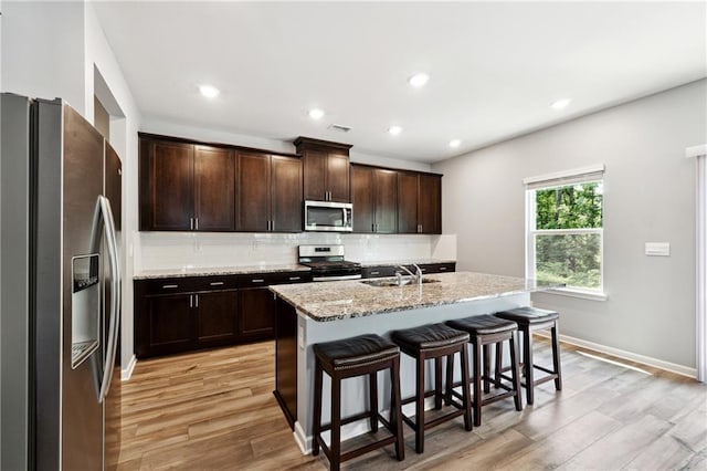 519 Magnolia Dr, Dawsonville, GA 30534 - kitchen with appliances with stainless steel finishes, a sink, decorative backsplash, light wood-type flooring, and recessed lighting