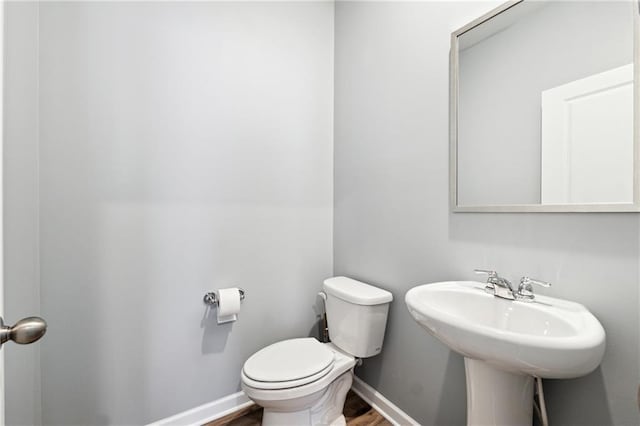 519 Magnolia Dr, Dawsonville, GA 30534 - half bath with toilet, wood finished floors, and baseboards