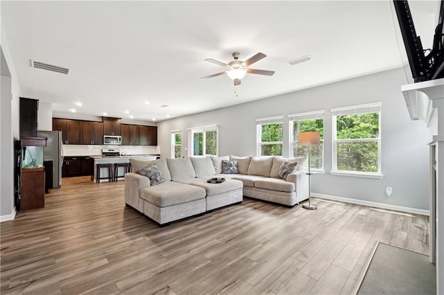 519 Magnolia Dr, Dawsonville, GA 30534 - living area featuring a ceiling fan, light wood-style flooring, baseboards, recessed lighting, and a fireplace