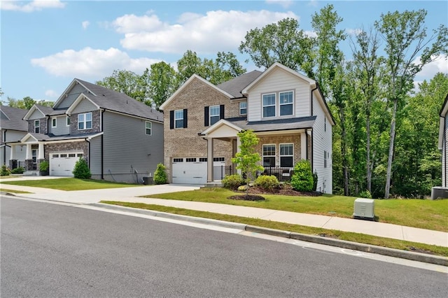 519 Magnolia Dr, Dawsonville, GA 30534 - craftsman inspired home featuring concrete driveway, an attached garage, a front lawn, a porch, and brick siding