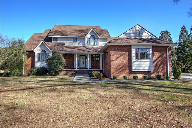317 Shenandoah Dr NE, Calhoun, GA 30701 - traditional-style house with a porch, brick siding, and a front lawn