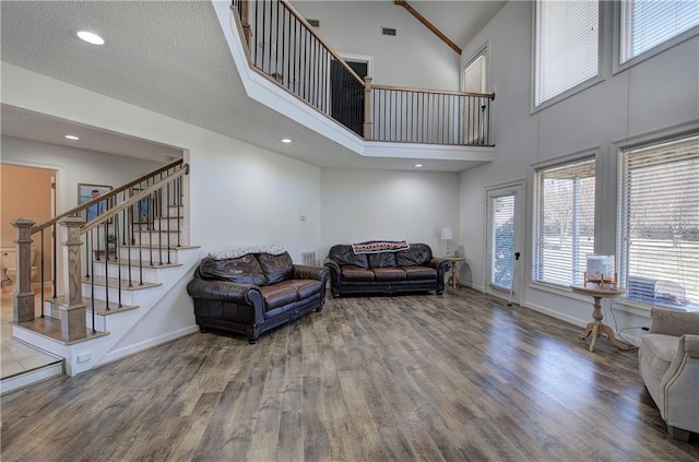 317 Shenandoah Dr NE, Calhoun, GA 30701 - living area featuring a high ceiling, stairway, wood finished floors, baseboards, and recessed lighting