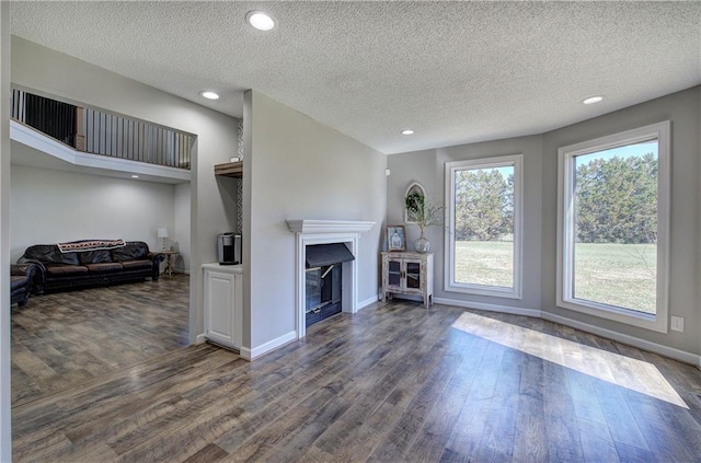 317 Shenandoah Dr NE, Calhoun, GA 30701 - living room featuring wood finished floors, baseboards, a textured ceiling, a fireplace, and recessed lighting