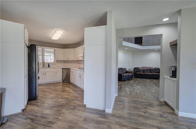 317 Shenandoah Dr NE, Calhoun, GA 30701 - kitchen with stainless steel appliances, dark wood-type flooring, white cabinetry, baseboards, and a textured ceiling