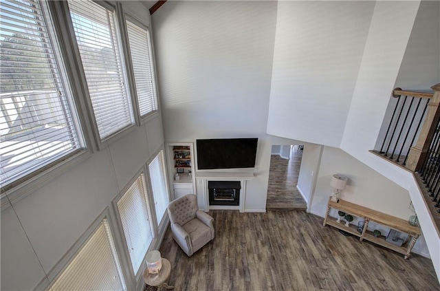 317 Shenandoah Dr NE, Calhoun, GA 30701 - living room with wood finished floors, a towering ceiling, a fireplace, and stairs