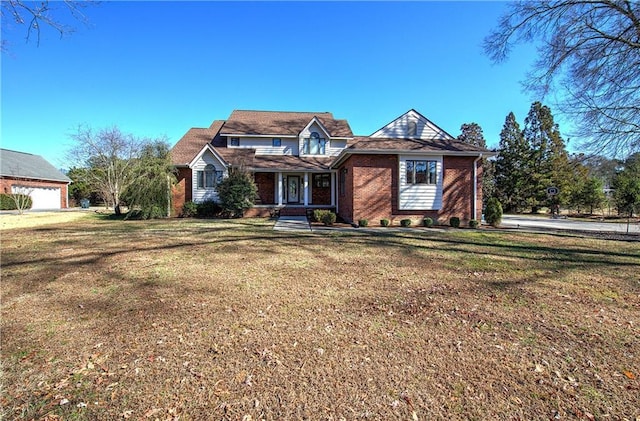 317 Shenandoah Dr NE, Calhoun, GA 30701 - traditional-style house with covered porch, brick siding, and a front lawn