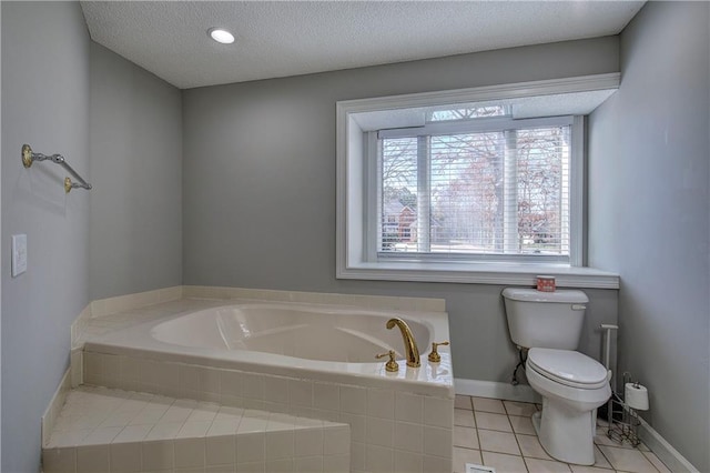 317 Shenandoah Dr NE, Calhoun, GA 30701 - full bathroom with a bath, toilet, a textured ceiling, tile patterned floors, and baseboards