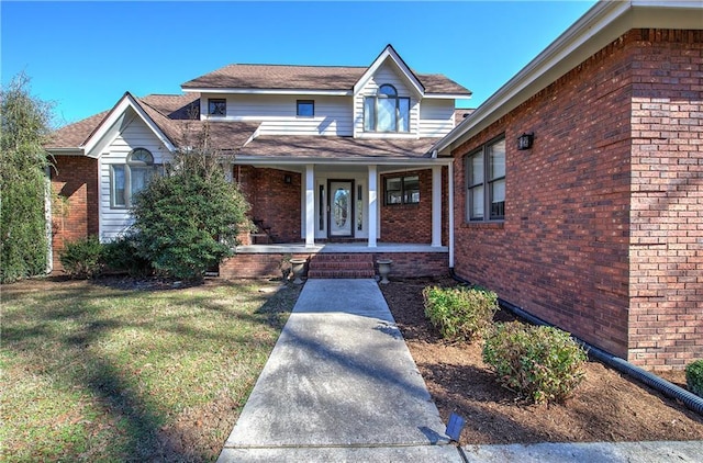 317 Shenandoah Dr NE, Calhoun, GA 30701 - view of front facade featuring a porch, brick siding, and a front lawn