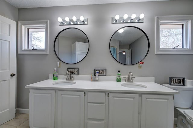 317 Shenandoah Dr NE, Calhoun, GA 30701 - full bathroom with toilet, double vanity, plenty of natural light, and tile patterned floors