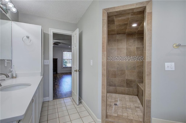 317 Shenandoah Dr NE, Calhoun, GA 30701 - bathroom featuring tile patterned flooring, vanity, a tile shower, baseboards, and ceiling fan