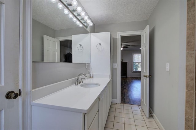317 Shenandoah Dr NE, Calhoun, GA 30701 - bathroom with a textured ceiling, tile patterned flooring, vanity, a ceiling fan, and baseboards