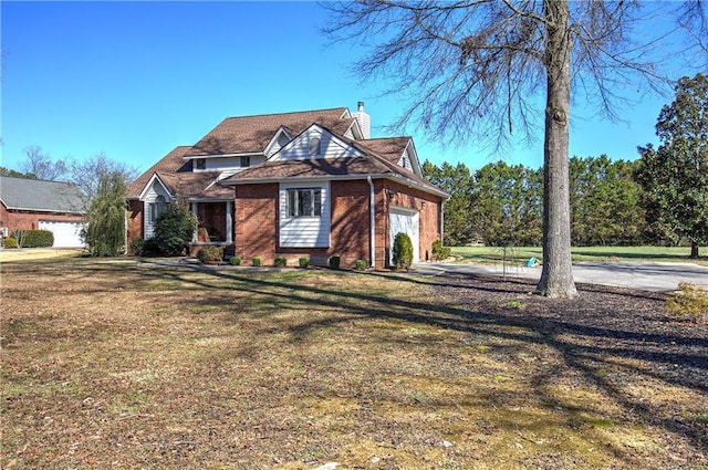 317 Shenandoah Dr NE, Calhoun, GA 30701 - view of front of house featuring a chimney, a garage, a front lawn, brick siding, and driveway