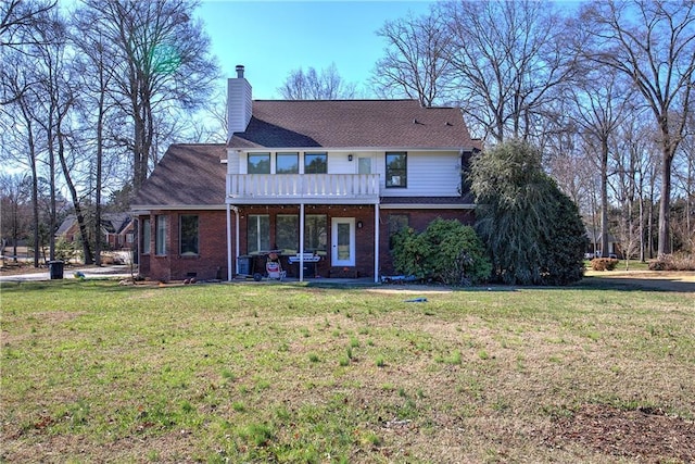 317 Shenandoah Dr NE, Calhoun, GA 30701 - view of front of home with a front yard, a chimney, and brick siding
