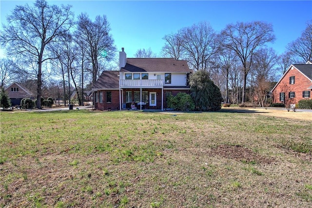 317 Shenandoah Dr NE, Calhoun, GA 30701 - rear view of house featuring a yard, a chimney, and brick siding
