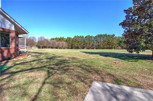 317 Shenandoah Dr NE, Calhoun, GA 30701 - view of grassy yard featuring a forest view