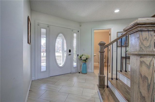 317 Shenandoah Dr NE, Calhoun, GA 30701 - foyer entrance featuring stairway, a textured ceiling, baseboards, and recessed lighting