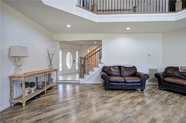 317 Shenandoah Dr NE, Calhoun, GA 30701 - living room with wood finished floors, stairway, baseboards, and recessed lighting