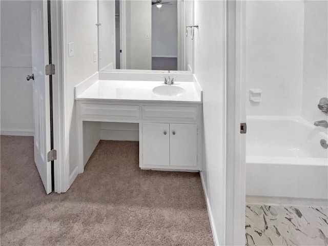 bathroom featuring vanity, ceiling fan, and washtub / shower combination