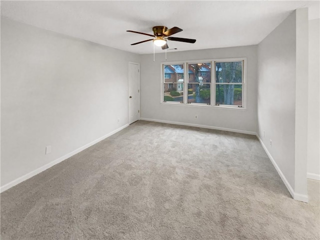 carpeted spare room featuring ceiling fan