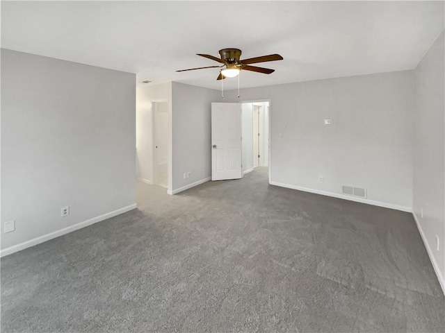 empty room featuring dark colored carpet and ceiling fan