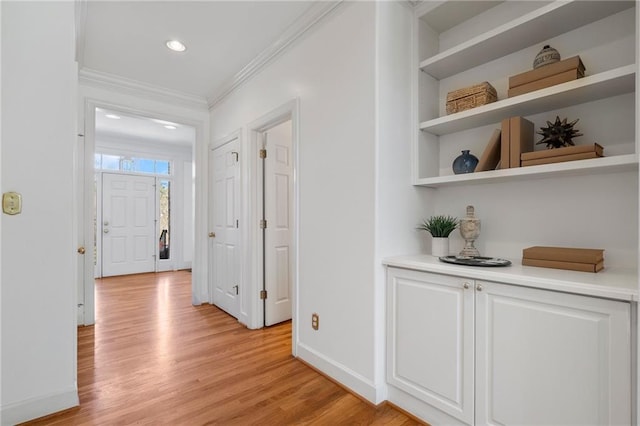 hallway with recessed lighting, baseboards, crown molding, and light wood finished floors