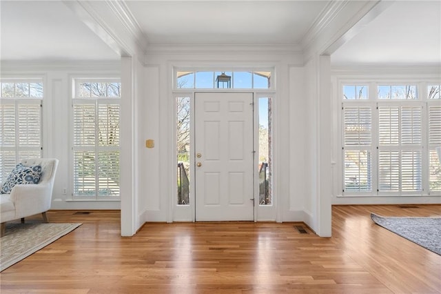 entryway featuring crown molding and wood finished floors