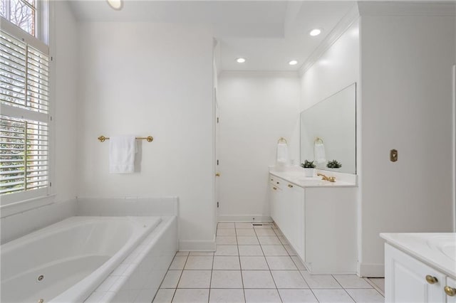 bathroom featuring tile patterned floors, vanity, a bath, and baseboards