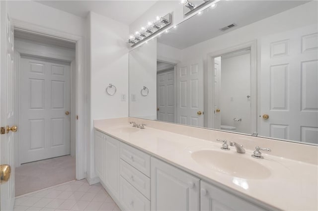 full bathroom featuring tile patterned flooring, visible vents, toilet, and a sink