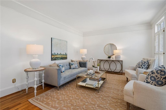 living area with baseboards, wood finished floors, and ornamental molding