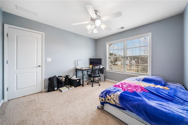 carpeted bedroom featuring ceiling fan and visible vents