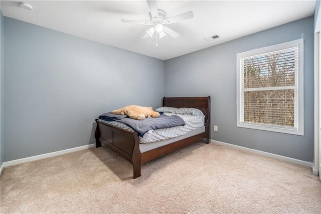 bedroom featuring ceiling fan, carpet, visible vents, and baseboards