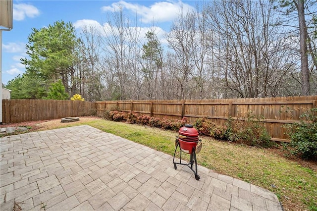 view of patio with a fenced backyard and a fire pit